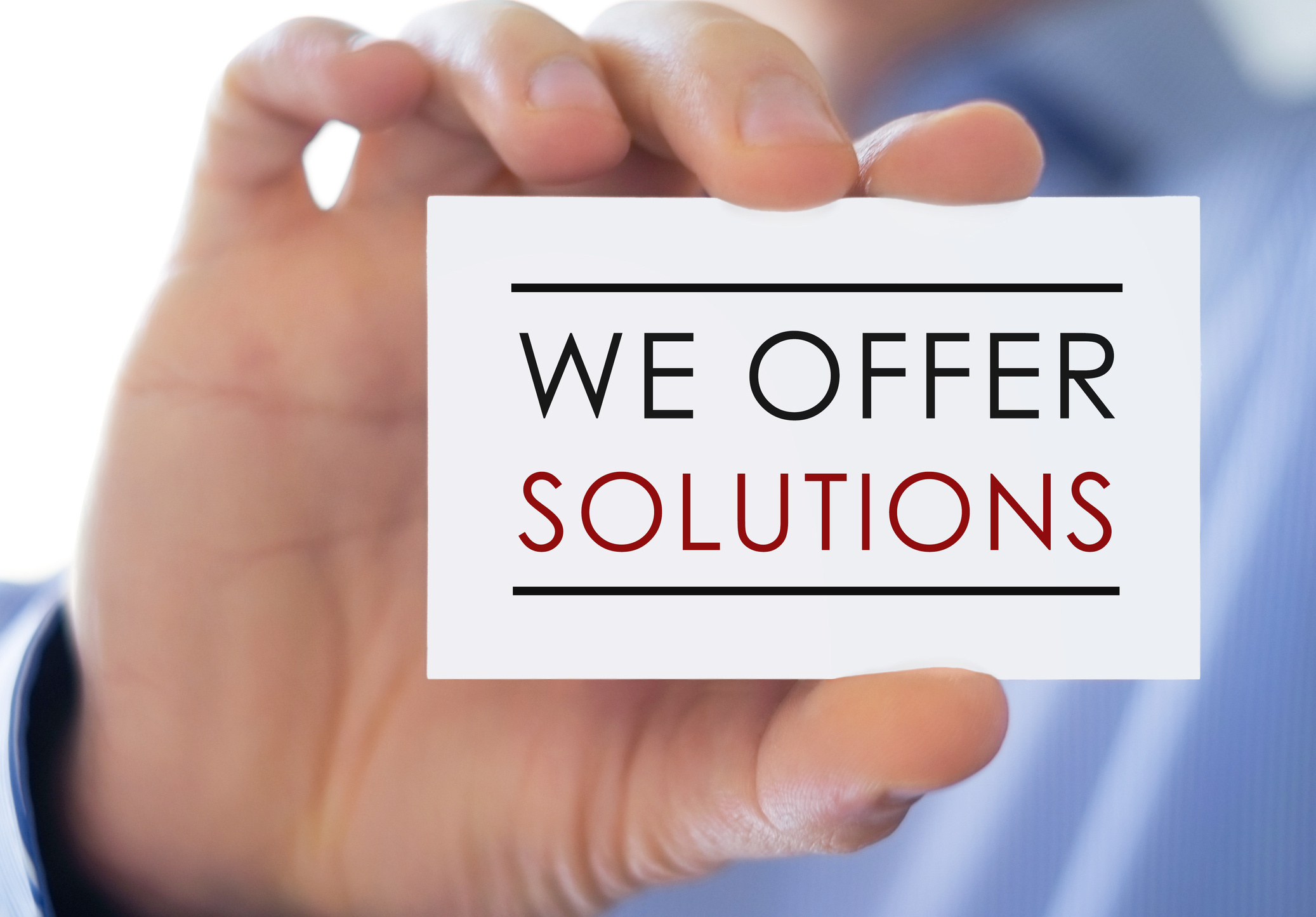 image of man holding we offer solutions card sign