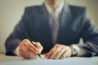 a man sitting at a table with a knife